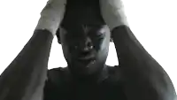a man with bandages on his wrists is holding his head