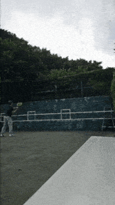 a tennis player is swinging a racket at a ball on a tennis court