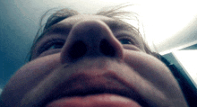 a close up of a person 's face with a very large nose