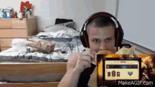 a man wearing headphones is eating a hamburger