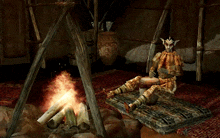 a video game character sits by a fire playing a drum