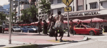 a group of people are standing in front of a dominion hotel