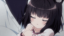 a girl with black hair and cat ears is sleeping on a bed