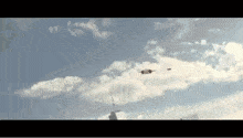 a helicopter is flying in the sky over a city .