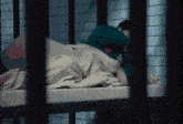 a person laying on a bed with a green shirt that says ss