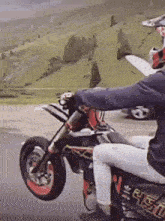 a person is riding a dirt bike on a road