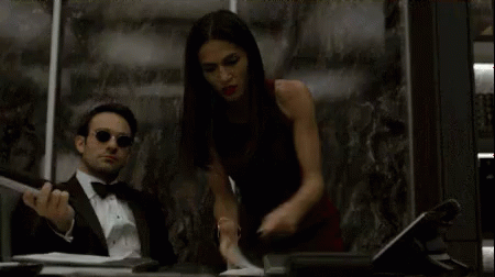 Flipping Through Books GIF - Charlie Cox And Elodie Yung Busy Daredevil GIFs