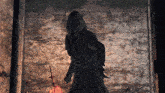 a person in a hooded robe holding a sword