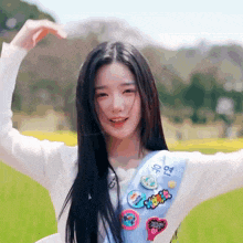 a girl wearing a sash that says ' i love you ' on it is making a heart shape with her hands