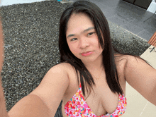 a woman in a bikini takes a selfie
