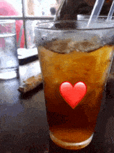 a glass of iced tea with a heart in the middle