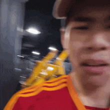 a blurry picture of a man wearing a red and orange shirt