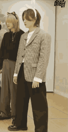 a man wearing bunny ears stands next to a man wearing a cat headband