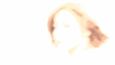 a blurry picture of a woman 's face with short brown hair