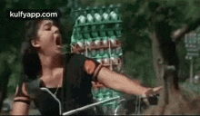 a woman is screaming while holding a sword in front of a stack of eggs .