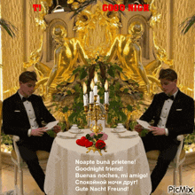 two men in tuxedos are sitting at a table with candles and flowers and a good night message