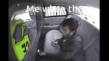 a man is sitting in the back seat of a police car with the words me when the written on the screen