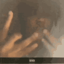 a person making an ok sign with the number 999 written on the bottom