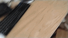 a computer keyboard is laying on a wooden surface