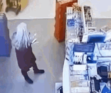 a woman in a santa claus costume is standing in a store .