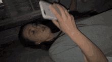 a woman is laying on a bed with a bottle of milk in her hand .