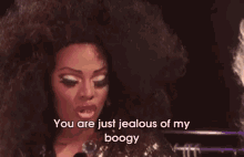 a woman with a big afro is saying `` you are just jealous of my booy '' .