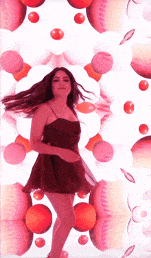 a woman in a red dress is dancing in front of a white background