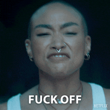 a woman with a nose ring is making a face and the word fuck off is above her head