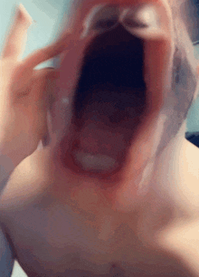 a close up of a person 's mouth with their tongue sticking out