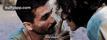 a man is kissing a woman on the forehead and asking her if she is stupid .