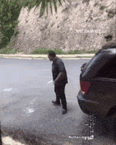 a man is standing next to a car with the caption rotten memes lll