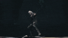 a woman in a pink dress is being attacked by a man in a black jacket .