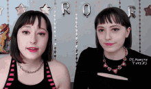 two women are standing next to each other and one has a necklace that says di pomite twins