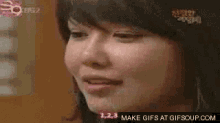 a close up of a woman 's face with a make gifs at gifsoup.com logo in the corner .