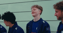 a man in a blue jacket with the letter c on the sleeve