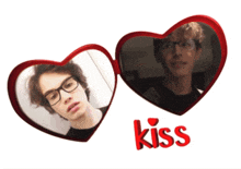 two heart shaped mirrors with the word kiss on the bottom right