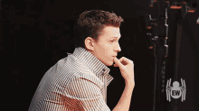 a man in a striped shirt with a ew logo on the bottom