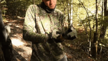 a man in a camo shirt with the letter g on it