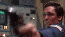 a man is pointing a gun at the camera with the number 09 in the background