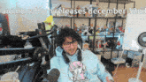 a man sitting in front of a microphone with the words anime reborn releases december 32nd written above him