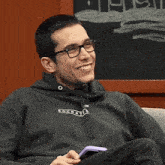 a man wearing glasses and a hoodie that says ' socrate ' on it