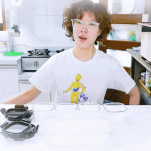 a woman wearing glasses and a t-shirt with a c-3po on it