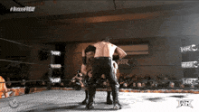 two men in a wrestling ring with the words #revolverfriday on the top