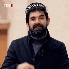 a man with a beard is wearing a hat that says trt1 on it