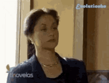 a woman is standing in front of a window and the words evolutionhn are on the bottom right