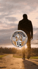 a man walking down a path with a uc logo