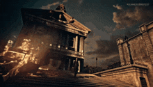 a man in a suit walks down a set of stairs in front of a burning building at summer game fest