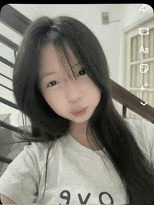 a girl with long hair is wearing a white t-shirt that says 9vo