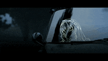 a drawing of a girl with long hair is on a car window