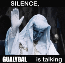 a statue of a man with the words silence gualybal is talking above him